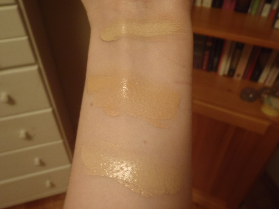 Foundation swatches on my arm in natural light, from top to bottom: Laura Mercier Silk Creme in Rose Ivory, Rimmel Wake Me Up in Ivory and MUFE HD in 115